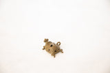 African vintage bronze wire turtle pendant with an intricate spiraling shell.