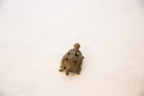 Angled rear view of a vintage bronze turtle pendant's intricate wire design shell.