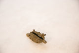 Side view of the vintage bronze turtle pendant showing its hollow form and textured body.