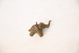 Profile view of the handmade bronze elephant pendant's mesh body and raised trunk.
