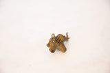 Close view of the bronze elephant pendant's hollow trunk and textured mesh pattern.