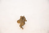 Angled view of the vintage bronze elephant pendant, detailing its textured head and mesh body.