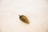 Hollow interior and oxidized surface of a vintage African bronze pendant.