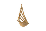 Vintage African bronze musical instrument with a rustic handmade texture and aged patina.