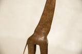 Etched surface details and warm aged patina on the vintage copper giraffe's neck.