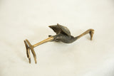Vintage bronze ostrich sculpture seen from above, highlighting its elongated neck and textured body.