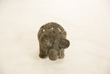 The textured face and coiled wire back of a vintage African elephant sculpture.