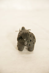 Rear view of the vintage African wire elephant showing its handmade coiled body and grid pattern.