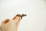 Side profile of the small, smooth African bronze hippo sculpture held in hand.