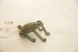 Close-up of vintage handmade African oxidized copper frog's textured green patina.