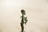 Profile view of the handmade African copper farmer highlighting its aged patina.