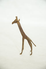 Stylized form of a vintage handmade bronze giraffe with a rustic, aged patina.
