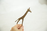 Vintage African bronze giraffe held in hand to show its collectible size.