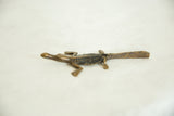Side profile of a handmade bronze crocodile with a textured, dark back.