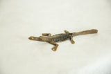 The dark textured back and sculpted form of a vintage African bronze crocodile.