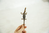 Vintage African bronze crocodile held to show scale and textured detail.