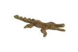 Vintage African bronze alligator figurine with a ridged back and aged patina.
