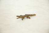 Angled view of a vintage bronze alligator showing its rustic, hand-cast texture.
