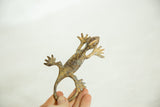 Aged bronze patina on the vintage African gecko's articulated tail and back legs.
