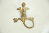 Vintage African bronze gecko sculpture with a textured, time-worn patina viewed from above.