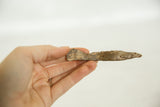 Vintage bronze eel sculpture held to display its handmade, textured finish.
