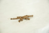 The textured surface and light patina of a small, vintage bronze alligator figurine.