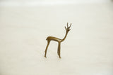 Bronze gazelle fawn sculpture with slender form, detailed antlers, and rich patina.