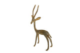 Vintage African bronze gazelle sculpture facing left, with long horns and a rustic patina.