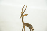Alert head and long neck of the vintage bronze gazelle, detailing the rustic, aged patina.