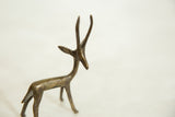 Detailed view of the alert head and slender horns of a vintage African bronze gazelle.