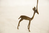 Vintage bronze gazelle sculpture shown in a graceful standing profile.