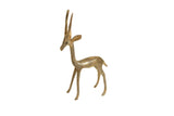 A slender vintage African bronze gazelle figurine with long upright horns and aged patina.