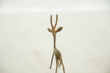 Rear view of a vintage bronze gazelle, showing the sculpture's slender form and horns.