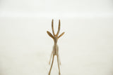 Forward-facing view of a vintage African bronze gazelle, highlighting its slender face and horns.