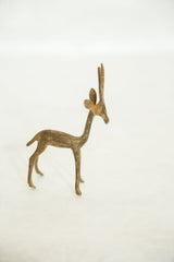 Vintage African bronze gazelle sculpture shown from the side with its head facing forward.
