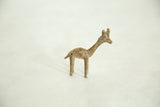 Profile view of a vintage African bronze giraffe with a rustic, pocked texture.