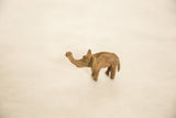 Textured, handmade African bronze elephant sculpture with trunk raised.