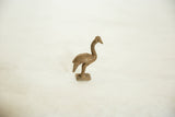 Profile view of a vintage African bronze ostrich with a textured patina.