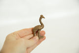 A hand holds the small vintage African bronze ostrich to show its scale and textured patina.