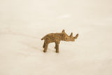 Handmade vintage African bronze rhinoceros, showing its textured surface and unique patina.