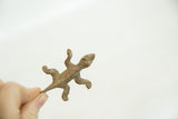 Textured vintage bronze striped lizard collectible sculpture held in hand.