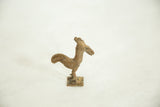 Side view of the vintage bronze rooster highlighting its handmade textural details.