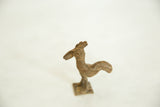 Vintage African bronze rooster from above, showing the stylized head and textured ribbed neck.