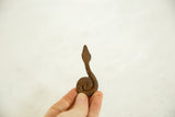 Handheld vintage African Iron Coiled Snake, with rustic patina and textured finish.
