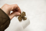 Scale and handmade texture of a vintage African bronze elephant face pendant.