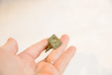 Aged patina and texture of a vintage African bronze rooster pendant base.