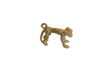 Vintage handmade African bronze monkey pendant with a rustic patina and stylized looped tail.