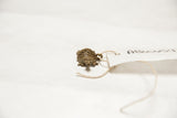 Angled view of the vintage African turtle pendant's textured bronze mesh shell.