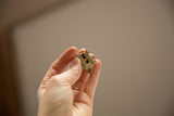 Angled view of the vintage bronze turtle showing its hollow wire-frame design.