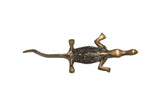 Vintage African bronze crocodile with a textured black back and a long curved tail.